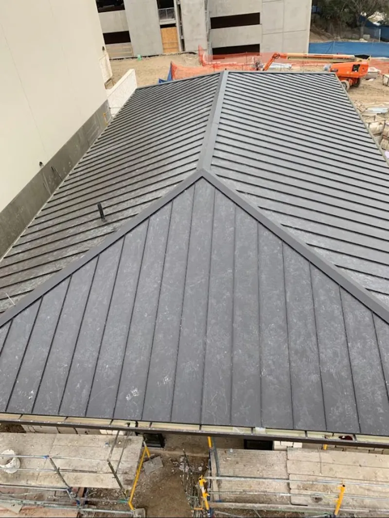 Commercial metal roof construction with crane equipment in Aiea